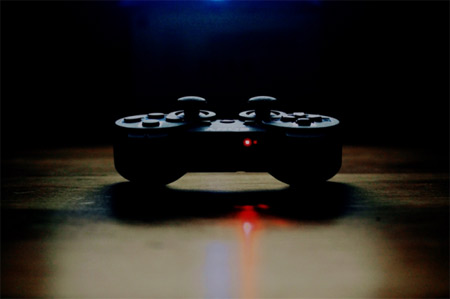 PlayStation DualShock controller in heavy shadows