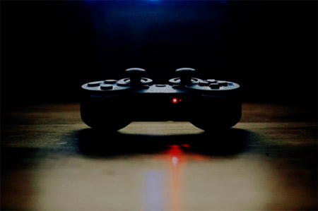 Monitor your child's online activity PlayStation DualShock controller in heavy shadows